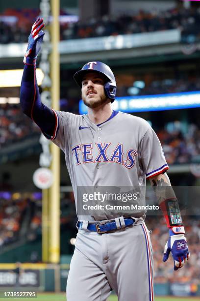 Jonah Heim of the Texas Rangers celebrates after hitting a solo home run against Framber Valdez of the Houston Astros during the third inning in Game...