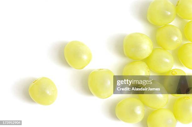 green grapes scattered - green grape stock pictures, royalty-free photos & images