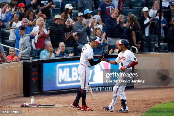 Jorge Polanco of the Minnesota Twins celebrates his solo home run with teammate Carlos Correa against the Texas Rangers in the sixth inning at Target...