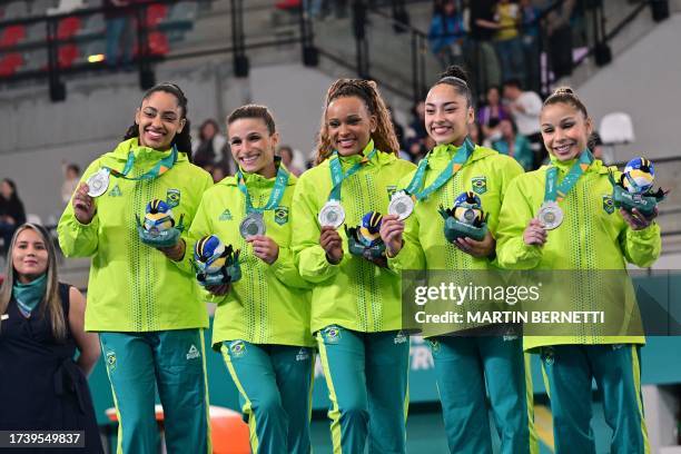 Brazil's team Carolyne Pedro, Jade Barbosa, Rebeca Andrade, Julia Soares and Flavia Saraiva pose after winning the silver medal in the women's team...