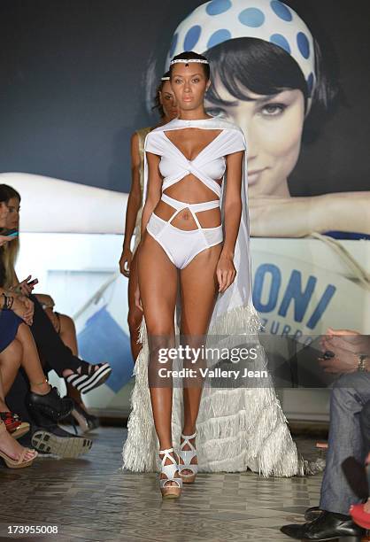 Models walks the runway during the Peroni Emerging Designer Series presented by Fashion Group on July 17, 2013 in Miami, Florida.