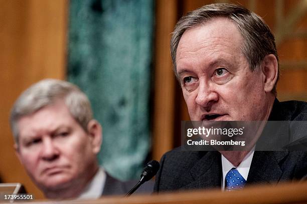 Senator Mike Crapo, a Republican from Idaho, right, questions Ben S. Bernanke, chairman of the U.S. Federal Reserve, not seen, during his semi-annual...