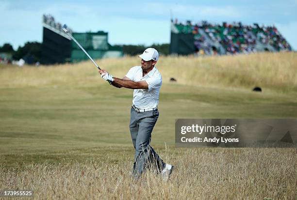 Charl Schwartzel of South Africa throws his club in reaction to a shot on the 15th hole during the first round of the 142nd Open Championship at...