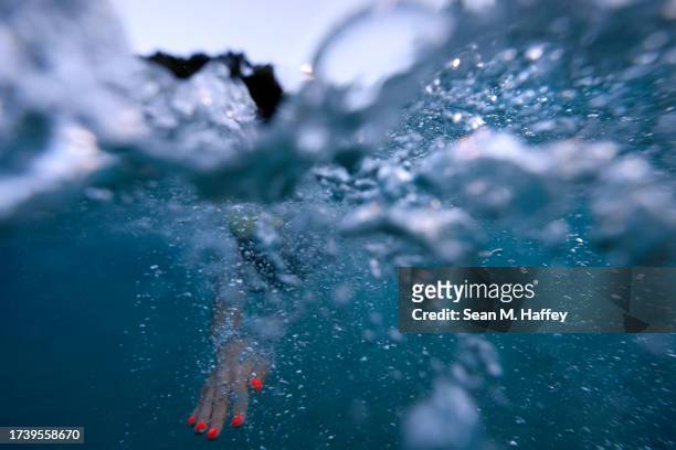 Brenda Avery of the United States competes in the swim course in the VinFast IRONMAN World Championship on October 14, 2023 in Kailua Kona, Hawaii.