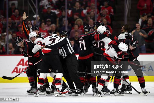 The Carolina Hurricanes and the Ottawa Senators scuffle during the second period of their game at PNC Arena on October 11, 2023 in Raleigh, North...