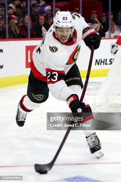 Travis Hamonic of the Ottawa Senators attempts to clear the puck during the second period of their game against the Carolina Hurricanes at PNC Arena...