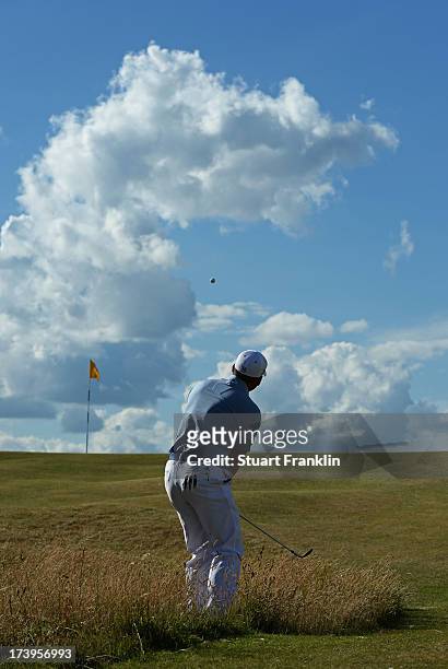 Sergio Garcia of Spain hits an approach shot on the 12th hole during the first round of the 142nd Open Championship at Muirfield on July 18, 2013 in...