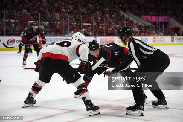 Claude Giroux of the Ottawa Senators and Jordan Staal of the Carolina Hurricanes prepare for a face-off during the second period of their game at PNC...