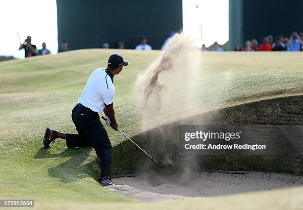 Tiger Woods of the United States plays out of a bunker on the 12th hole during the first round of the 142nd Open Championship at Muirfield on July...