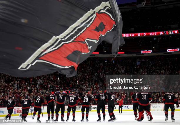 The Carolina Hurricanes acknowledge the fans following their 5-3 victory over the Ottawa Senators at PNC Arena on October 11, 2023 in Raleigh, North...