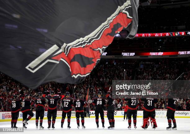 The Carolina Hurricanes acknowledge the fans following their 5-3 victory over the Ottawa Senators at PNC Arena on October 11, 2023 in Raleigh, North...