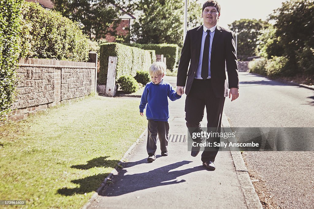 Father and son walking home from school