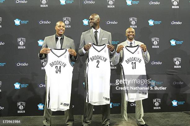 July 18: Kevin Garnett, Paul Pierce, and Jason Terry of the Brooklyn Nets pose with their new jerseys during a press conference at the Barclays...