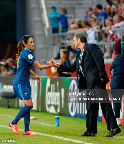 France's defender Wendie Renard celebrates with her head coach Bruno Bini after scoring during the UEFA Women's European Championship Euro 2013 group...