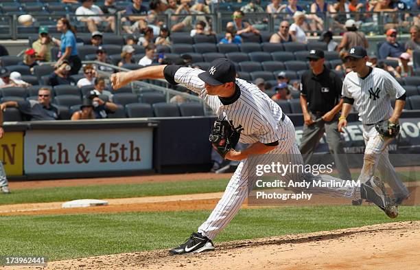 Preston Claiborne of the New York Yankees pitches against the Minnesota Twins at Yankee Stadium on July 14, 2013 in the Bronx borough of New York...