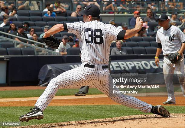 Preston Claiborne of the New York Yankees pitches against the Minnesota Twins at Yankee Stadium on July 14, 2013 in the Bronx borough of New York...