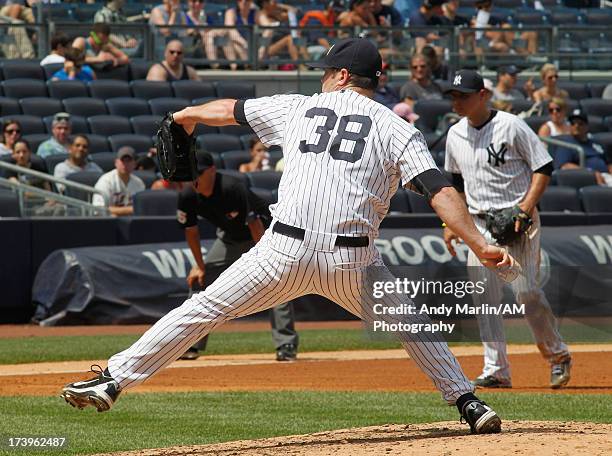 Preston Claiborne of the New York Yankees pitches against the Minnesota Twins at Yankee Stadium on July 14, 2013 in the Bronx borough of New York...