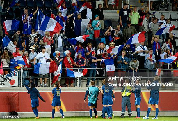 France's players celebrate with their supporters after winning the UEFA Women's European Championship Euro 2013 group C football match France vs...