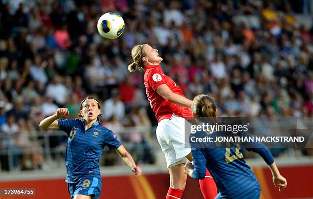 France's midfielder Elise Bussaglia and defender Sabrina Delannoy vie for the ball with England's forward Ellen White during the UEFA Women's...