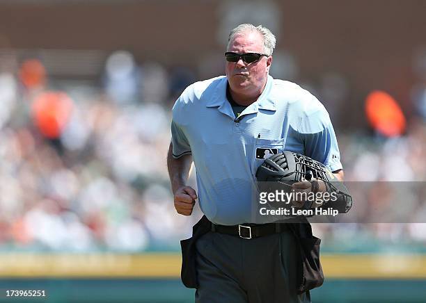 Major League Umpire Tim Welke runs back to his position during the game between the Texas Rangers and the Detroit Tigers at Comerica Park on July 14,...