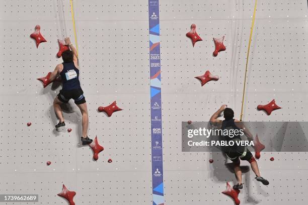 Samuel Watson and US' Noah Bratschi compete in the men's speed final climbing event during the Pan American Games Santiago 2023, at the Climbing...