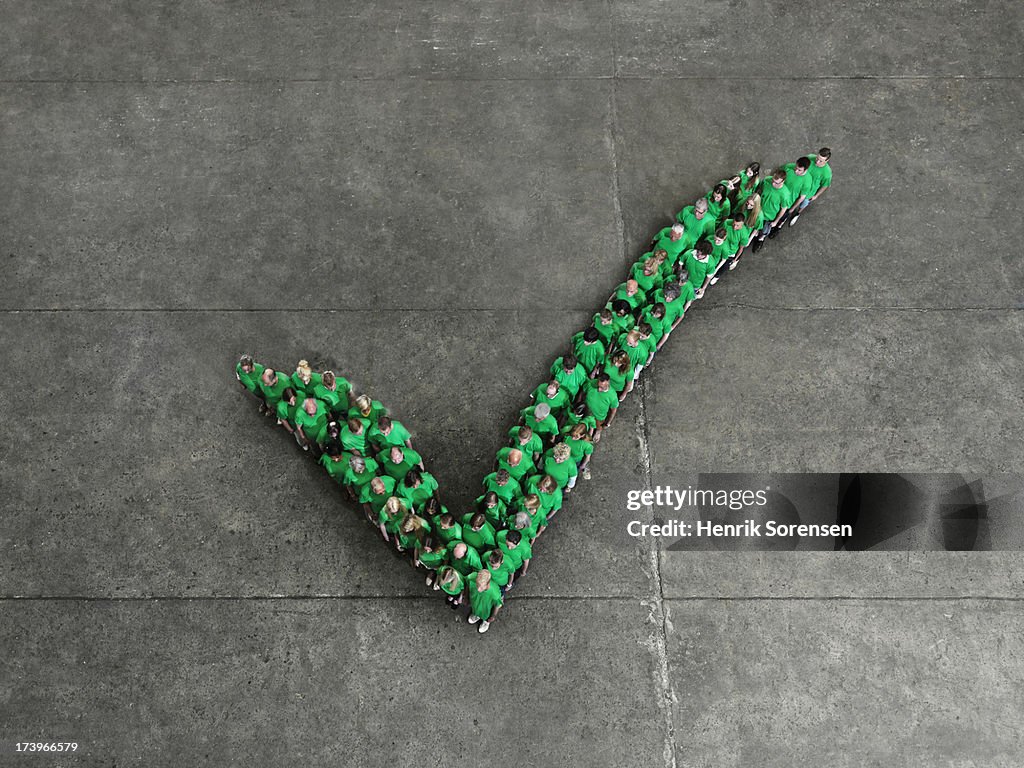 Crowd forming a check mark