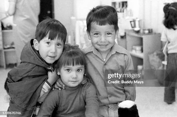 Three young first graders in their first day of class at San Juan Pueblo elementary school at the San Juan Pueblo, New Mexico, 1973. .