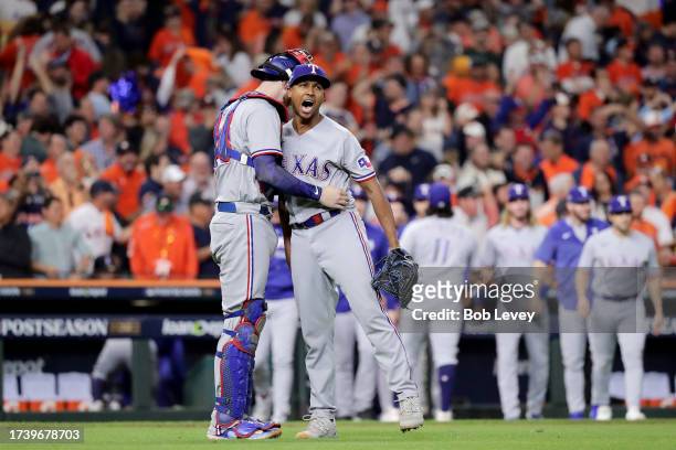 Jose Leclerc and Jonah Heim of the Texas Rangers celebrate after defeating the Houston Astros in Game Two of the American League Championship Series...