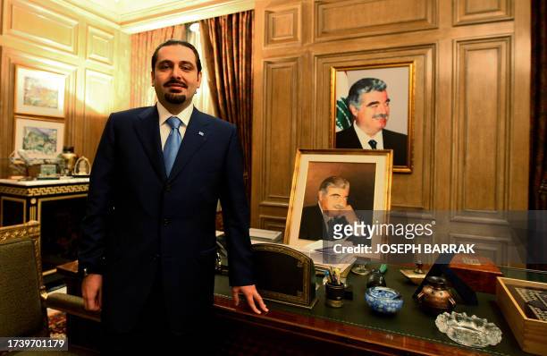 Saad Hariri, leader of Lebanon's parliamentary majority, poses near pictures of his late father Rafiq Hariri, who was killed in a massive car bomb in...