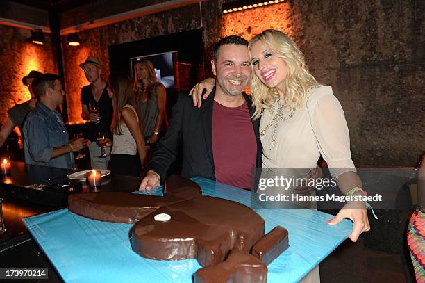 Pedro da Silva and Verena Kerth pose with her birthday cake during the Verena Kerth birthday party at P1 on July 18, 2013 in Munich, Germany. Kerth...
