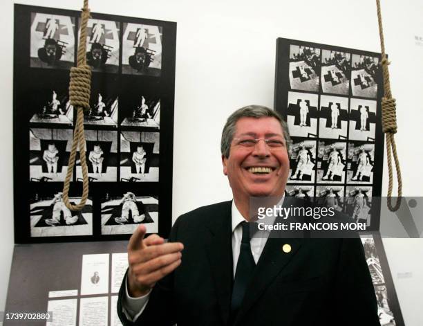 French deputy and mayor of Levallois-Perret Patrick Balkany stands next to "Suicide Series" by Chinese artist Wei Guangqing, as he visits an...