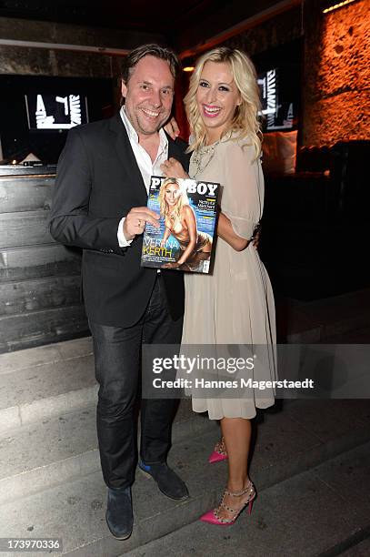 Playboy editor in chief Florian Boitin and Verena Kerth pose with the new Playboy during the Verena Kerth birthday party at P1 on July 18, 2013 in...