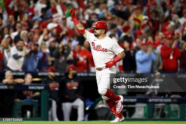 Kyle Schwarber of the Philadelphia Phillies rounds the bases after hitting a solo home run in the first inning against the Arizona Diamondbacks...