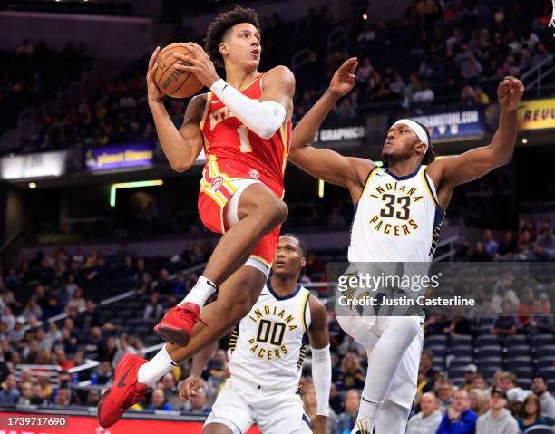 Jalen Johnson of the Atlanta Hawks drives to the basket while defended by Myles Turner of the Indiana Pacers during the first half at Gainbridge...