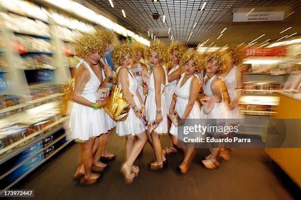 Women dressed as Marilyn Monroe walk during the presentation of the series 'Smash' at FNAC store on July 18, 2013 in Madrid, Spain.