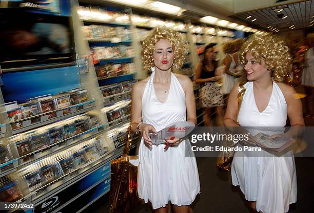 Women dressed as Marilyn Monroe walk during the presentation of the series 'Smash' at FNAC store on July 18, 2013 in Madrid, Spain.