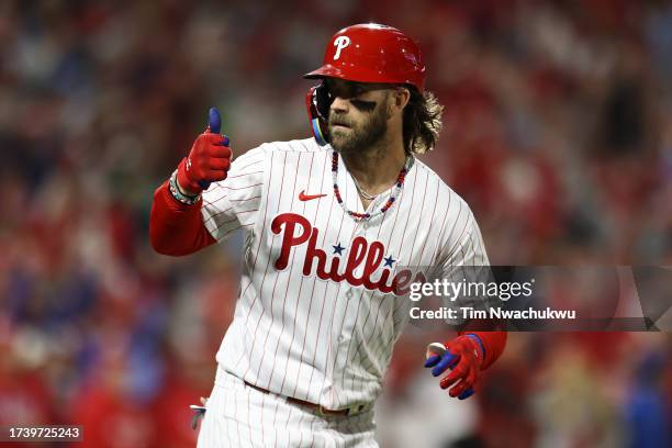 Bryce Harper of the Philadelphia Phillies reacts after hitting a solo home run in the first inning against the Arizona Diamondbacks during Game One...