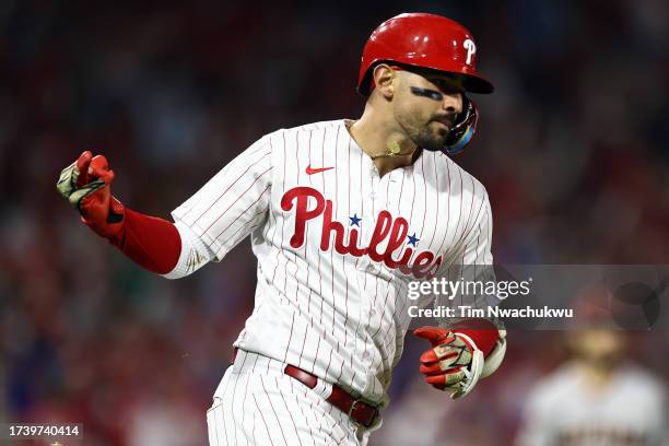 Nick Castellanos of the Philadelphia Phillies gestures to the dugout after hitting a solo home run in the second inning against the Arizona...