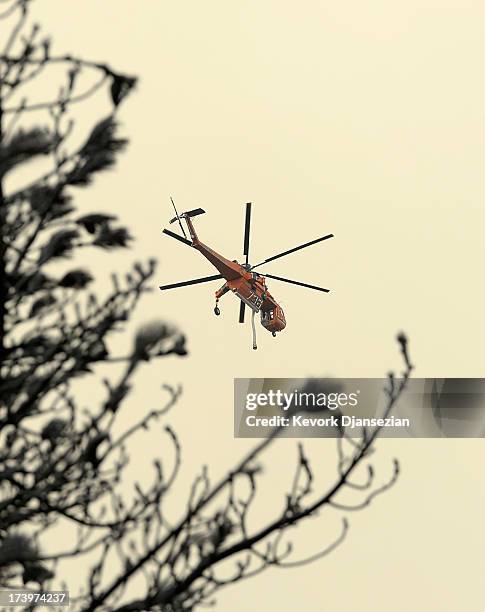 Fire fighting helicopter heads out to fight the Mountian Fire on July 18, 2013 in Idyllwild, California. The massive wildfire in Riverside county has...