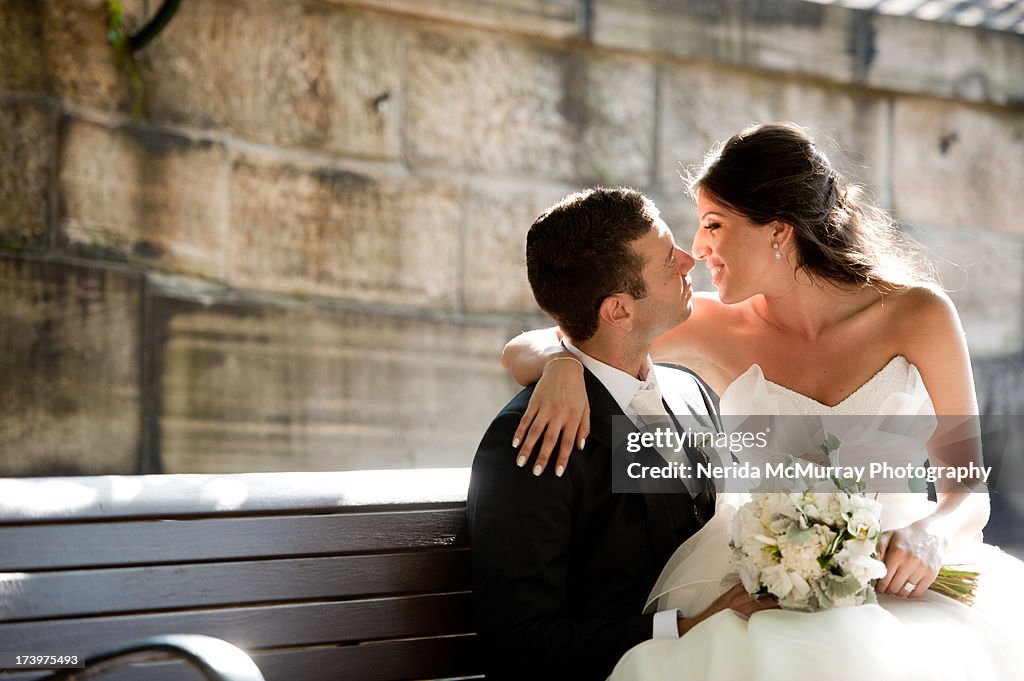 Bride sitting on groom's lap