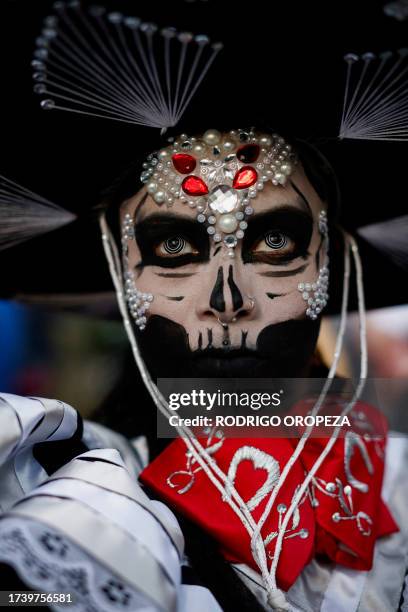 Woman dressed as a Catrin takes part in the Procession of Catrinas at the Reforma avenue in Mexico City, on October 22, 2023.