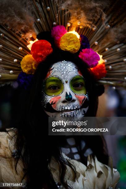 Woman dressed as a Catrin takes part in the Procession of Catrinas at the Reforma avenue in Mexico City, on October 22, 2023.