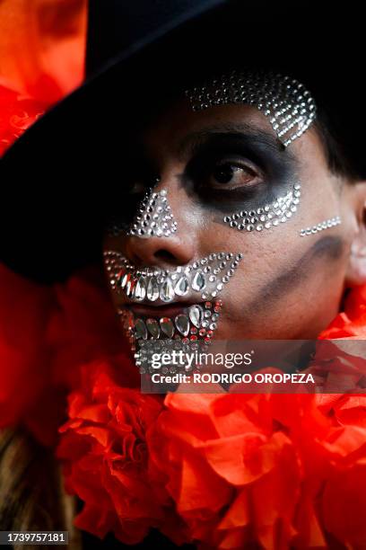 Man dressed as a Catrin takes part in the Procession of Catrinas at the Reforma avenue in Mexico City, on October 22, 2023.