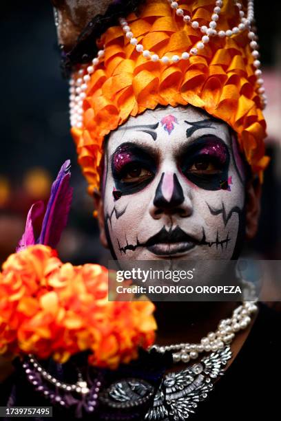 Man dressed as a Catrin takes part in the Procession of Catrinas at the Reforma avenue in Mexico City, on October 22, 2023.