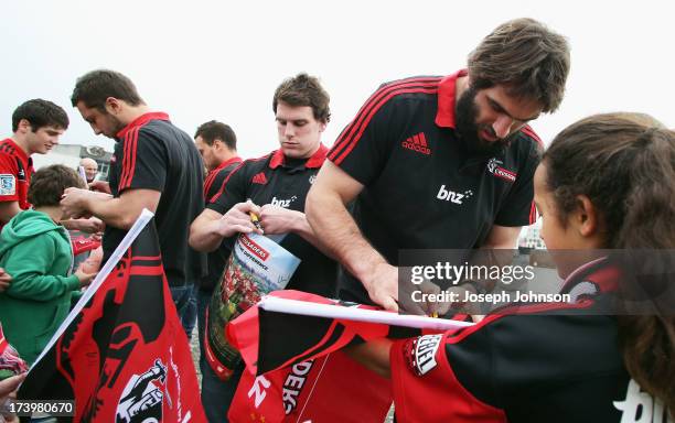 Tom Taylor, Matt Todd and Sam Whitelock of the Crusaders sign autographs after a media announcement that BNZ will be naming rights sponsor of the...