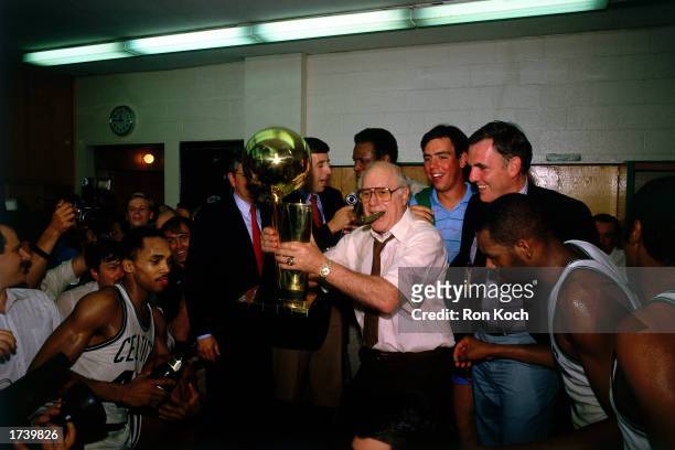 Head coach of the Boston Celtics Red Auerbach holds the NBA Championship Trophy after winning the 1984 NBA Championship at the Boston Garden on June...