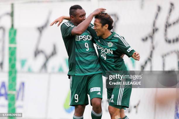 Yoshiro Abe of Matsumoto Yamaga celebrates with teammate Obina after scoring his team's second goal during the J.League J1 first stage match between...