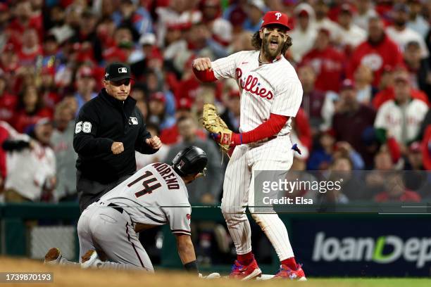 Bryce Harper of the Philadelphia Phillies reacts after an out in the seventh inning against the Arizona Diamondbacks during Game One of the...