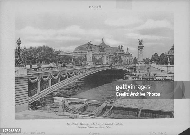 The Pont Alexandre III, an ornate, arch bridge that spans the Seine, connecting the Champs-Élysées and Eiffel Tower quarter, with a view of the...