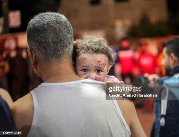 Palestinians injured in Israeli air raids arrive on October 17, 2023 in Khan Yunis, in the southern Gaza Strip, Gaza. Gazans are evacuating to the...